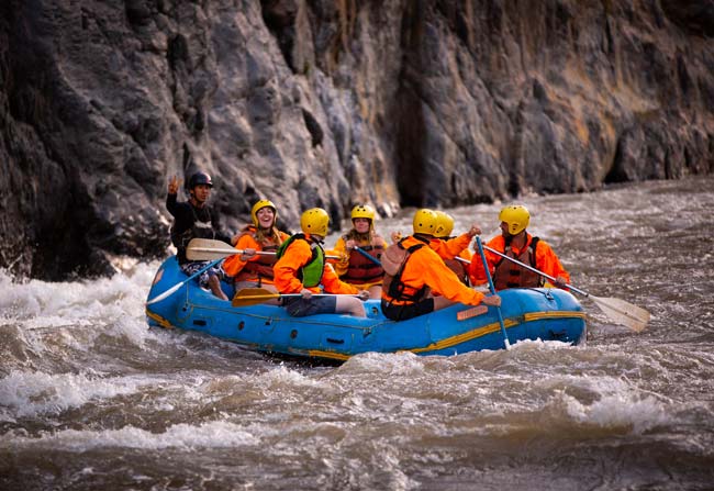 Inca Jungle, Adventure Guide, Travelers rafting on a river surrounded by green mountains and jungle scenery during the Inca Jungle Trek in Peru
