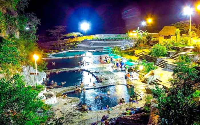 Visitors relaxing in the Cocalmayo hot springs at night, Peru